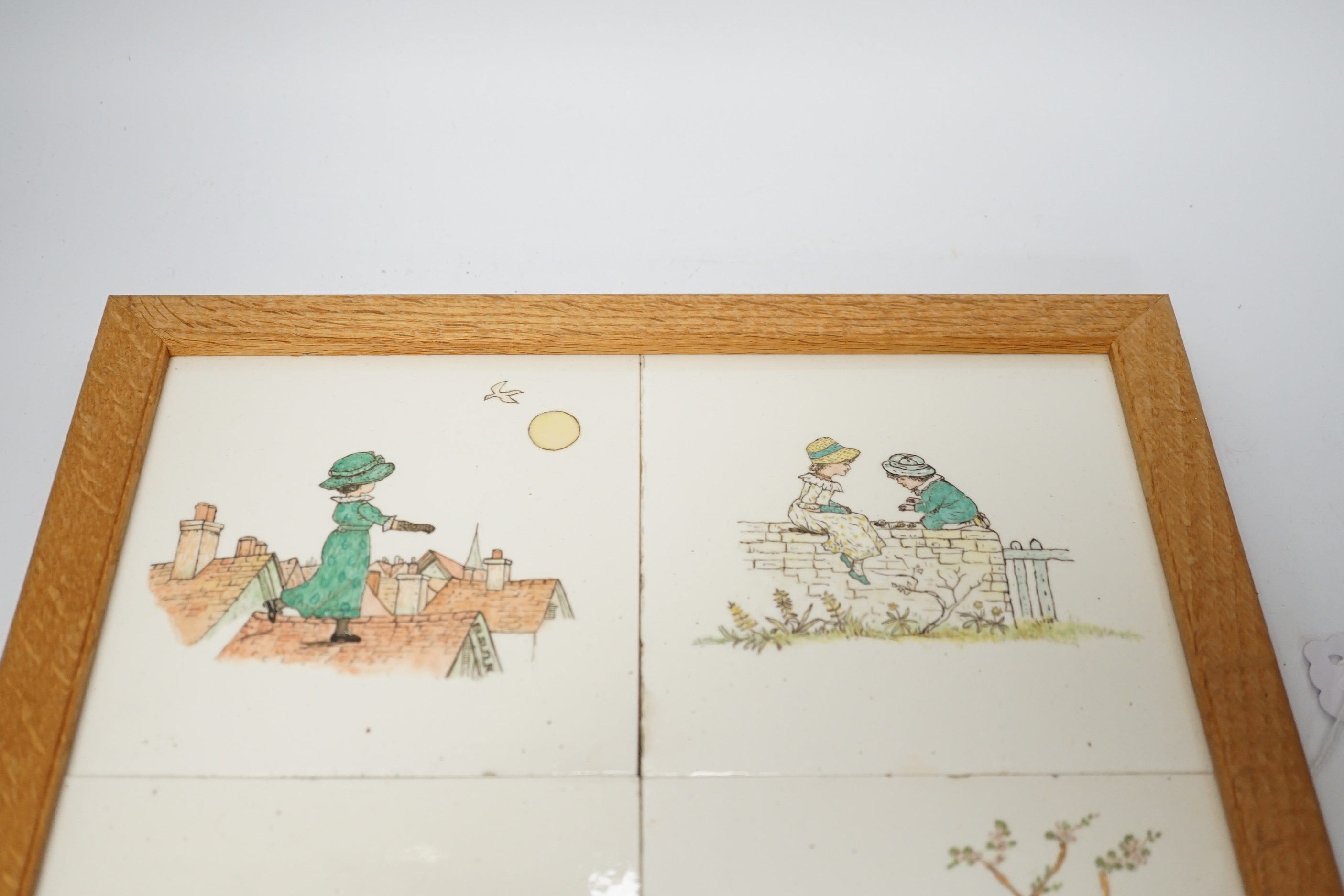 A set of four oak framed Minton tiles outside decorated illustrations after Kate Greenaway, 34 x 34cm